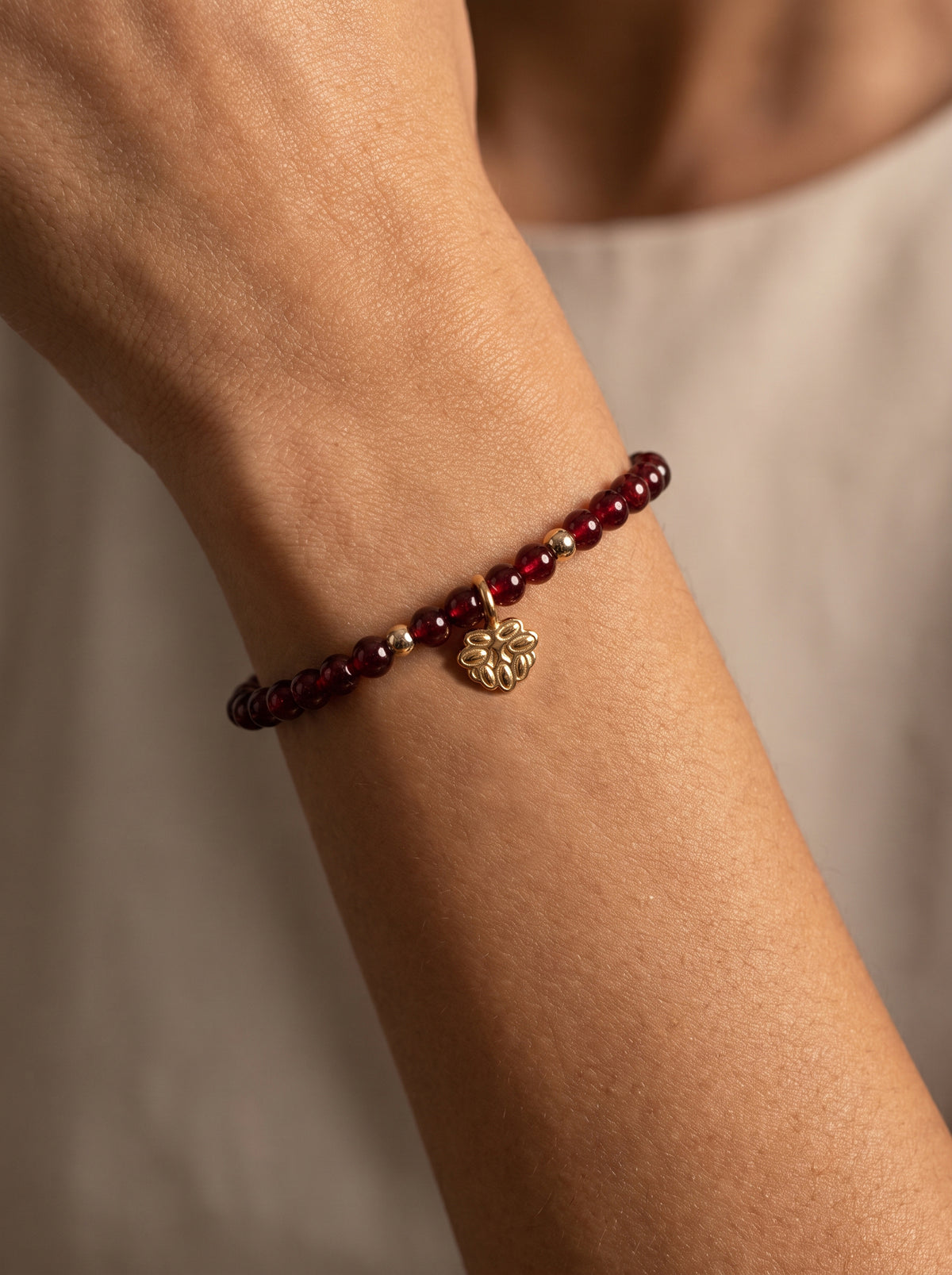 Garnet Root Chakra Lotus Charm Bracelet worn on wrist